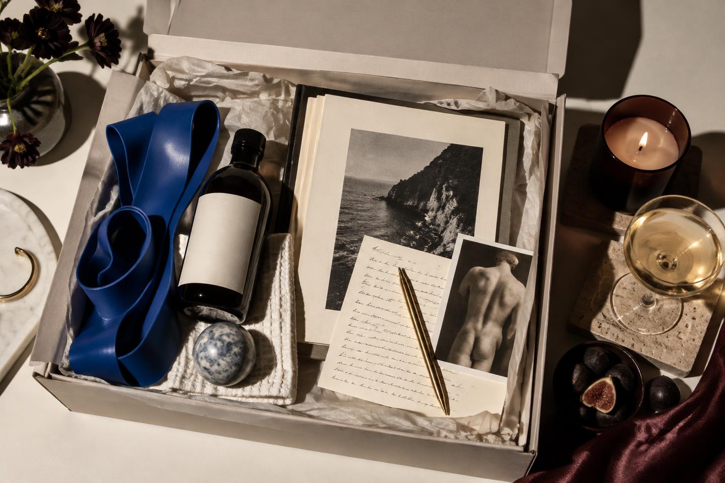 Editorial still life of an open monthly box with morning, reading and evening rituals